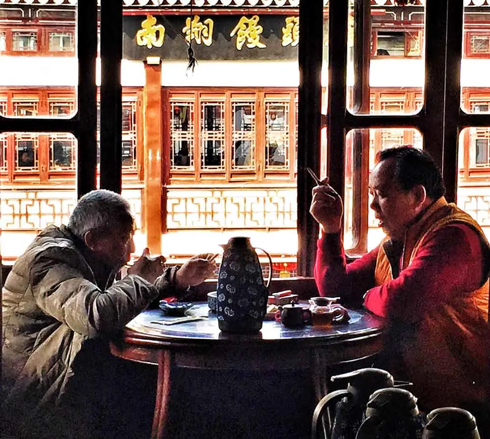 Two locals in china eat food and drinking tea cost of travel in china